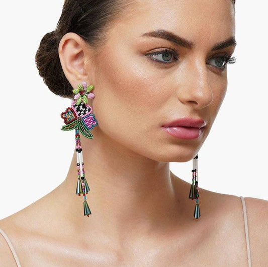 woman wearing beaded multi colored dangle earrings