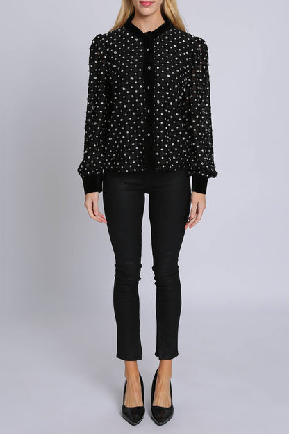 woman wearing black blouse with rhinestone embellisment and black leggings and black heels