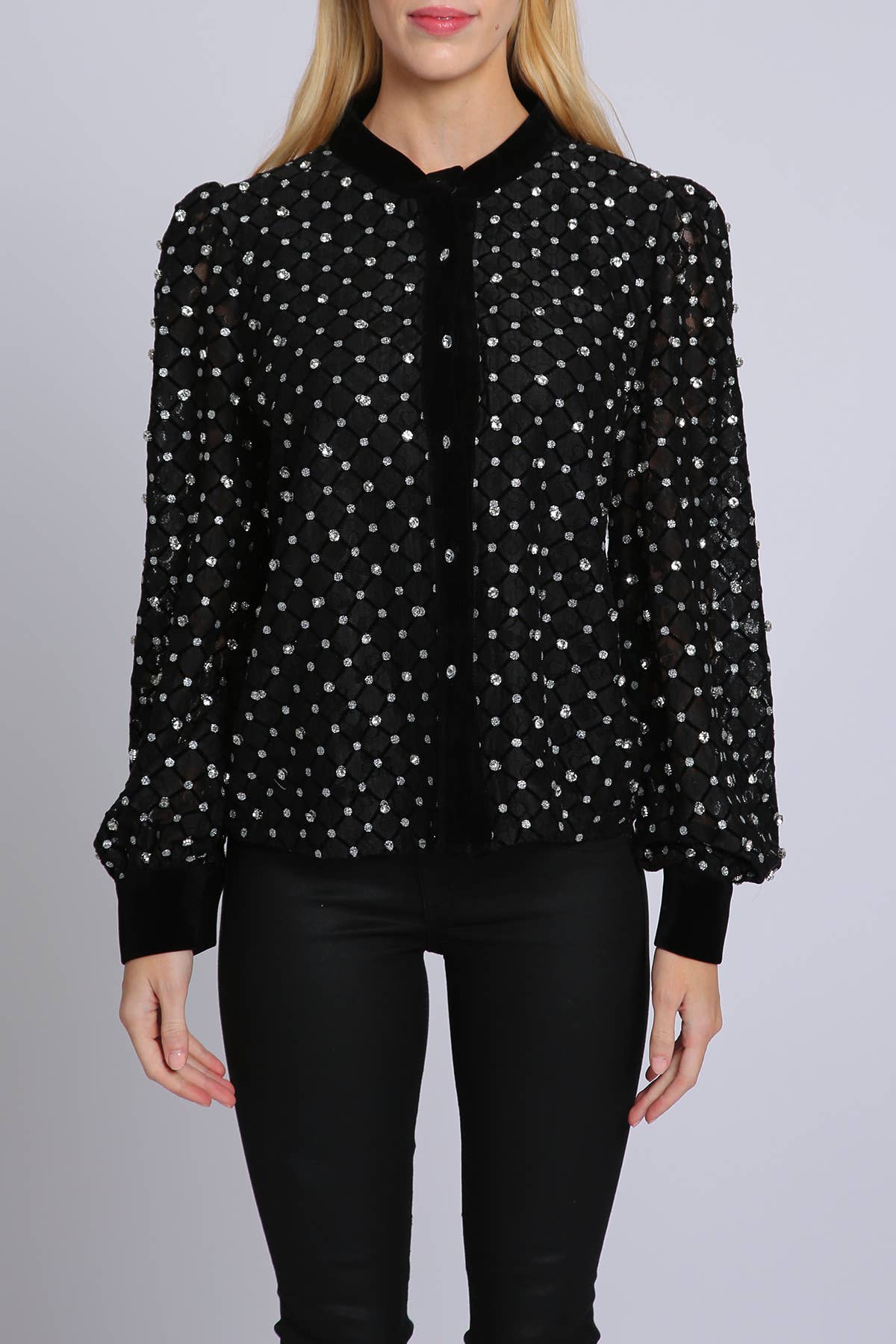 woman wearing black blouse with rhinestone embellisment and black leggings