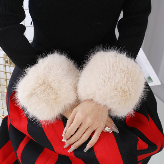 woman wearing ivory faux fur arm cuffs in black sweater and red & black skirt