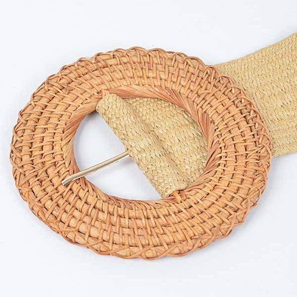 up close view of tan round rattan belt buckle