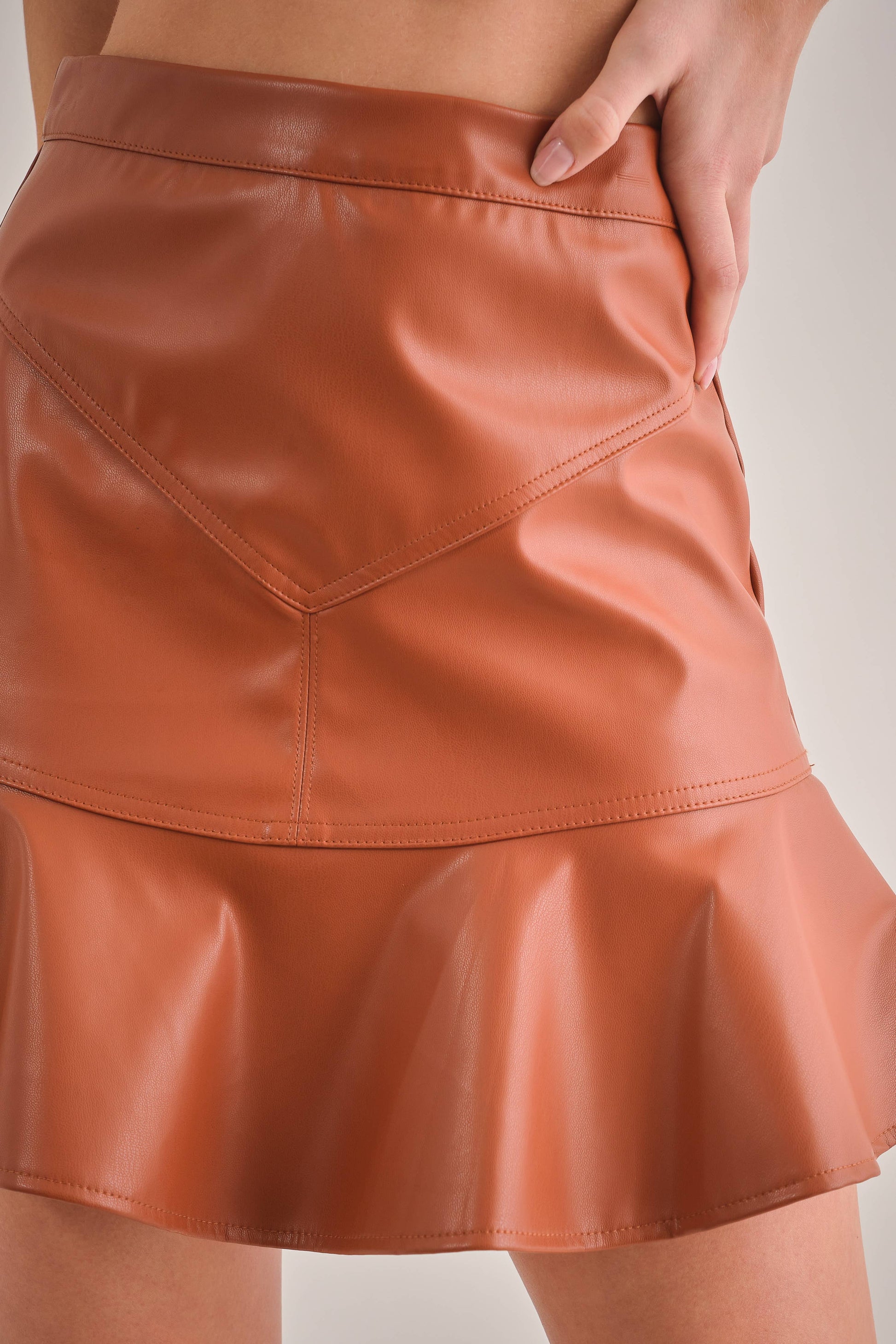 up close view of brown vegan leather skirt